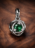 Green Eternity Circle Dangle Charm — display on walnut