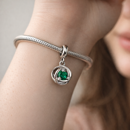 Green Eternity Circle Dangle Charm — worn on wrist