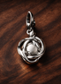 Clear Eternity Circle Dangle Charm — display on walnut