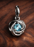 Sea Aqua Blue Eternity Circle Dangle Charm — display on walnut