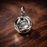 Silver Clear Knot Charm - Silver Clear Knot Charm — display on walnut