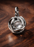 Silver Clear Knot Charm - Silver Clear Knot Charm — display on walnut