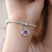 Purple Eternity Circle Dangle Charm — worn on wrist