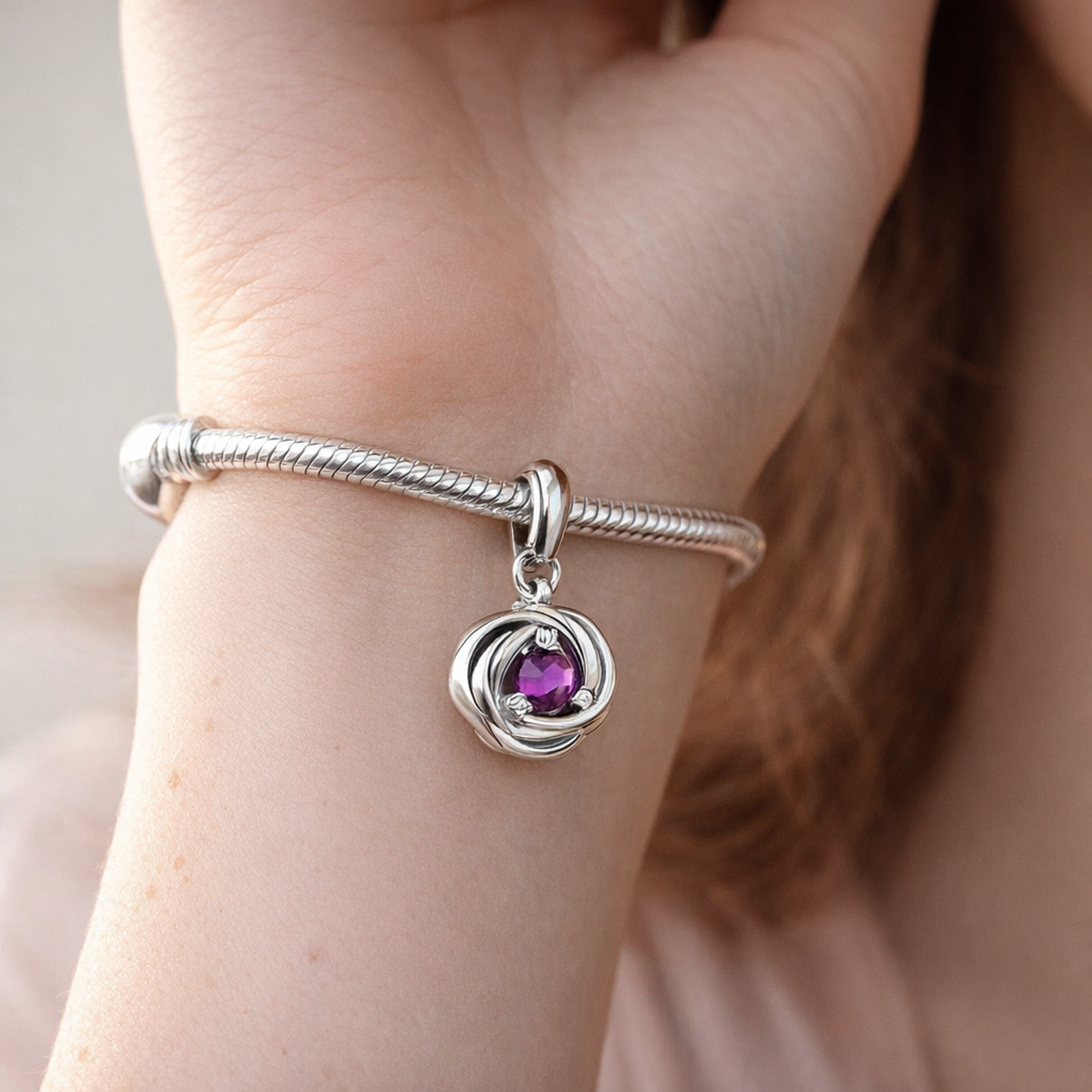 Purple Eternity Circle Dangle Charm — worn on wrist