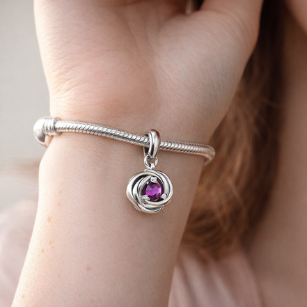 Purple Eternity Circle Dangle Charm — worn on wrist