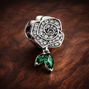 Sparkling Rose in Bloom Charm — display on walnut