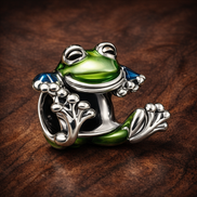 Climbing Frog Charm — display on walnut