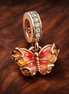 Pink & Yellow Murano Glass Butterfly Dangle Charm — display on walnut