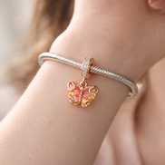 Pink & Yellow Murano Glass Butterfly Dangle Charm — worn on wrist