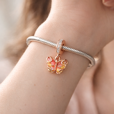 Pink & Yellow Murano Glass Butterfly Dangle Charm — worn on wrist