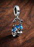 Disney Donald Duck Dangle Charm — display on walnut