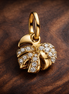 Sparkling Monstera Leaf Dangle Charm — display on walnut