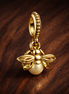 Gold Plated Flower Dangle Charm - Gold Plated Flower Dangle Charm — display on walnut