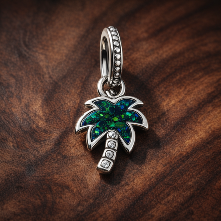 Opalescent Green Palm Tree Dangle Charm — display on walnut