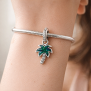 Opalescent Green Palm Tree Dangle Charm — worn on wrist