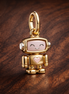 Spinnable Face Robot Dangle Charm — display on walnut