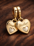 Double Heart Split Dangle Charm — display on walnut