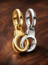 Two-Tone Handcuffs - Two-Tone Handcuffs Charm — display on walnut