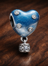 Hot Air Balloon Heart Charm — display on walnut