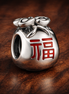 Silver Lucky Fu Bag Charm - Silver Fu Lucky Bag Charm — display on walnut