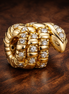 Curled Snake Charm — display on walnut