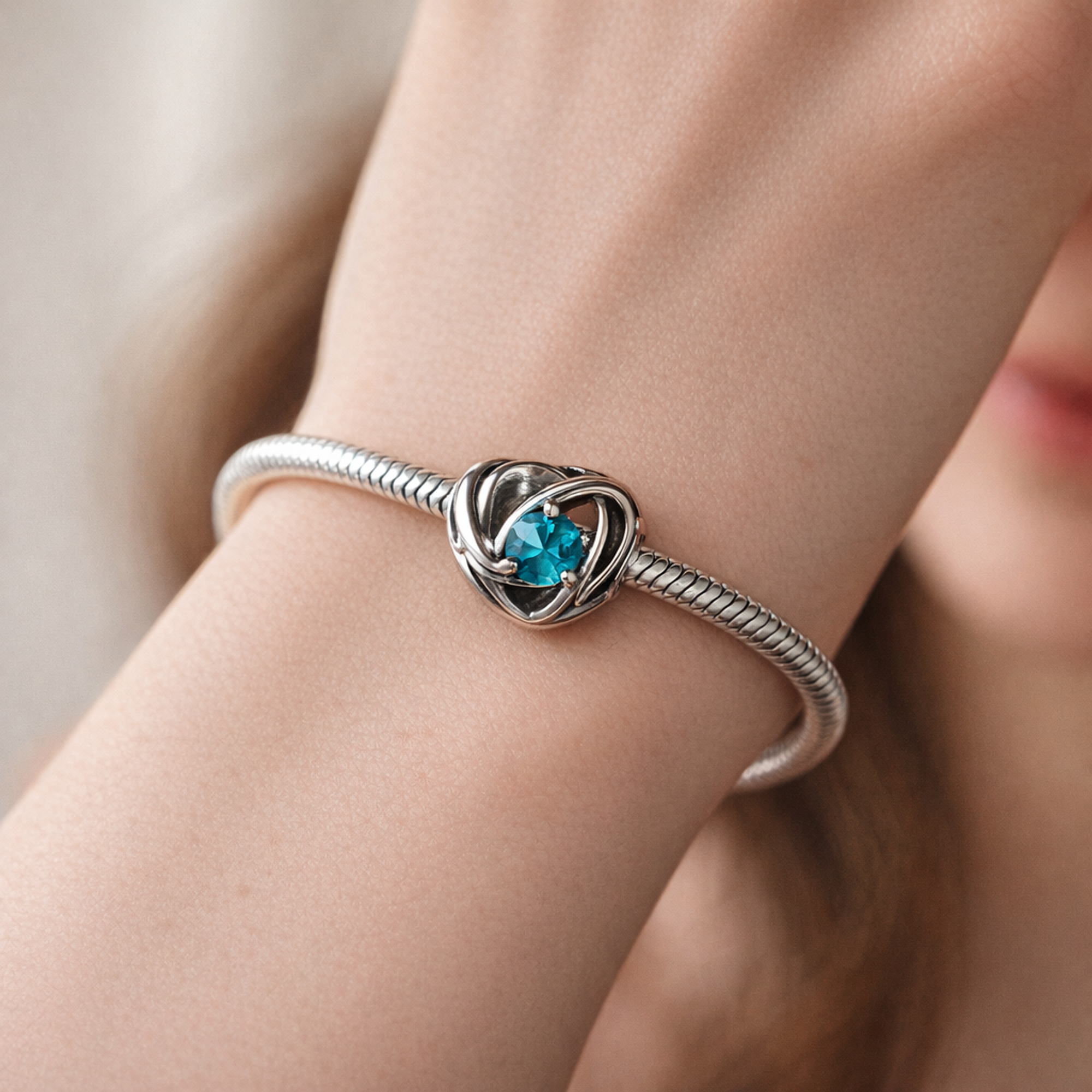 Entwined Heart Charm for UNICEF — worn on wrist