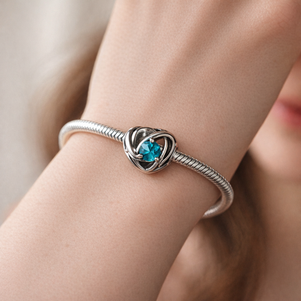 Entwined Heart Charm for UNICEF — worn on wrist