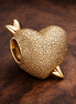 Cupid Heart Charm — display on walnut