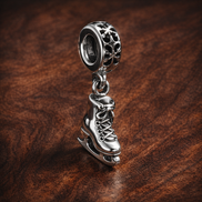 Snowflake Skate Dangle Charm - Snowflake Skate Charm — display on walnut