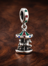 Spinning Carousel Dangle Charm — display on walnut