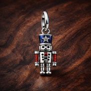 Moveable Nutcracker Dangle Charm — display on walnut