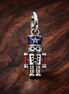 Moveable Nutcracker Dangle Charm — display on walnut