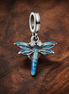 Dragonfly Double Dangle Charm — display on walnut