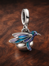 Hummingbird Double Dangle Charm - ZZ1883_2 — display on walnut