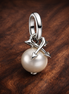 Pearl & Arrows Mini Dangle Charm — display on walnut