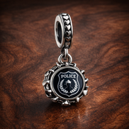 Police Dangle Charm — display on walnut