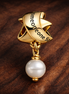Treated Freshwater Cultured Pearl Ribbon Charm — display on walnut
