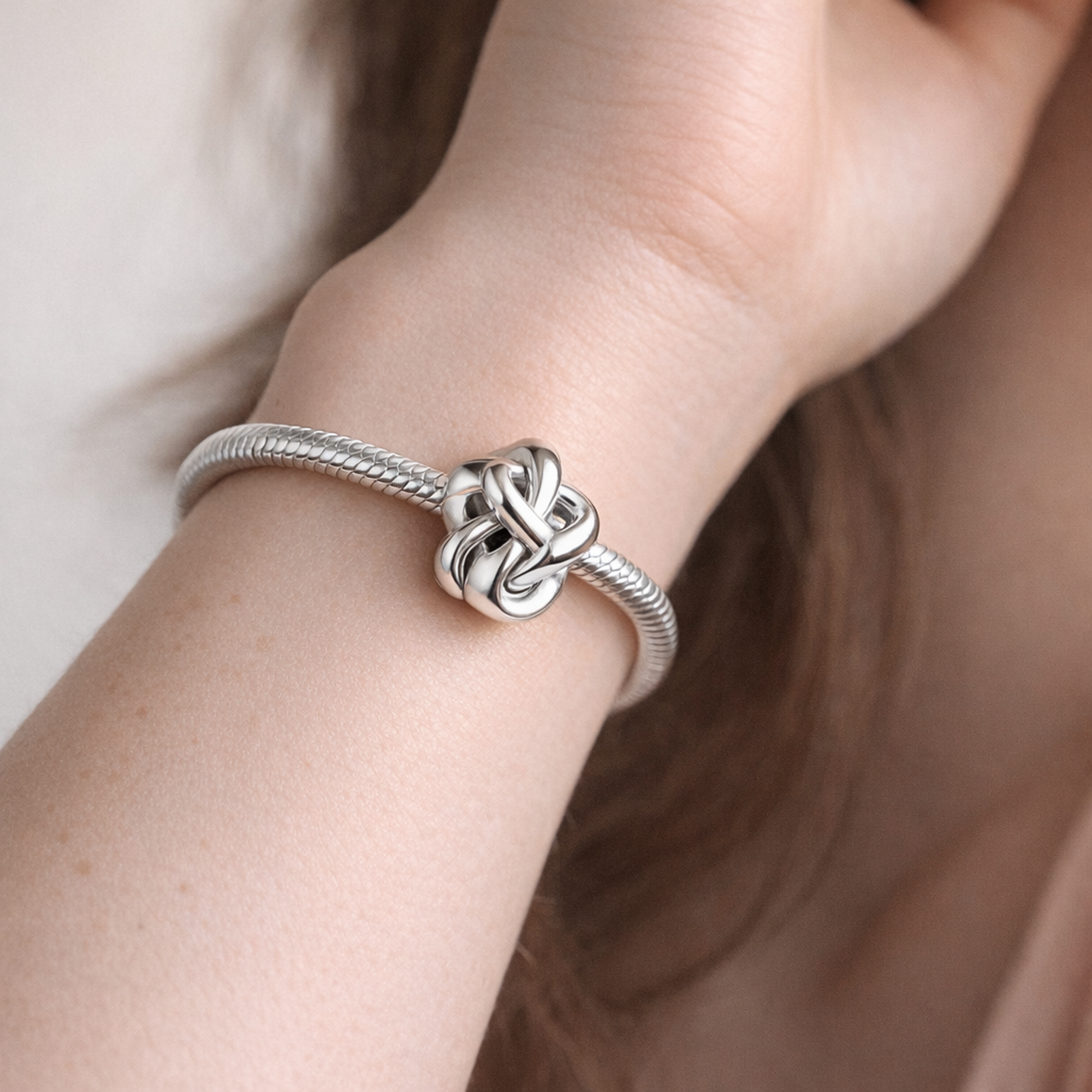Infinity Knot Charm — worn on wrist