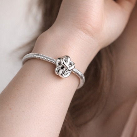 Infinity Knot Charm — worn on wrist