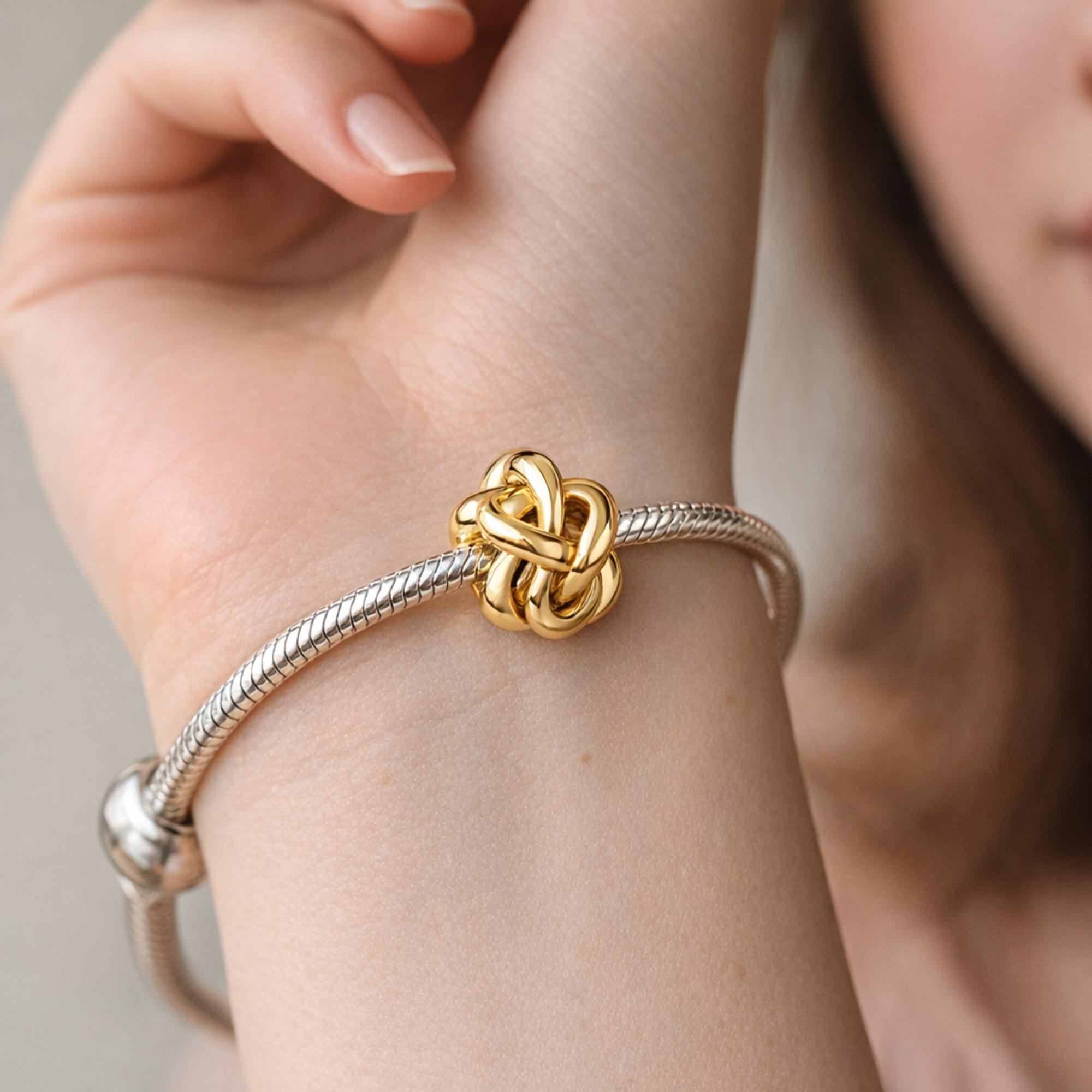 Infinity Knot Charm — worn on wrist