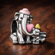Disney Dumbo & Mom Charm — display on walnut