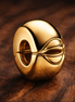 Round Clip Charm — display on walnut