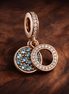 Rose Gold Plated Double Circles - Rose Gold Plated Double Circles Charm — display on walnut