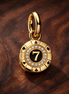 Lucky Chip Dangle Charm — display on walnut
