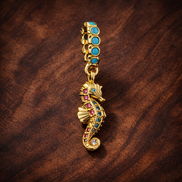 Seahorse Dangle Charm — display on walnut
