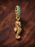 Seahorse Dangle Charm — display on walnut