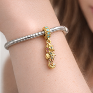 Seahorse Dangle Charm — worn on wrist