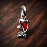 Red Murano Glass Koi Fish Mini Dangle Charm — display on walnut