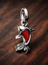 Red Murano Glass Koi Fish Mini Dangle Charm — display on walnut