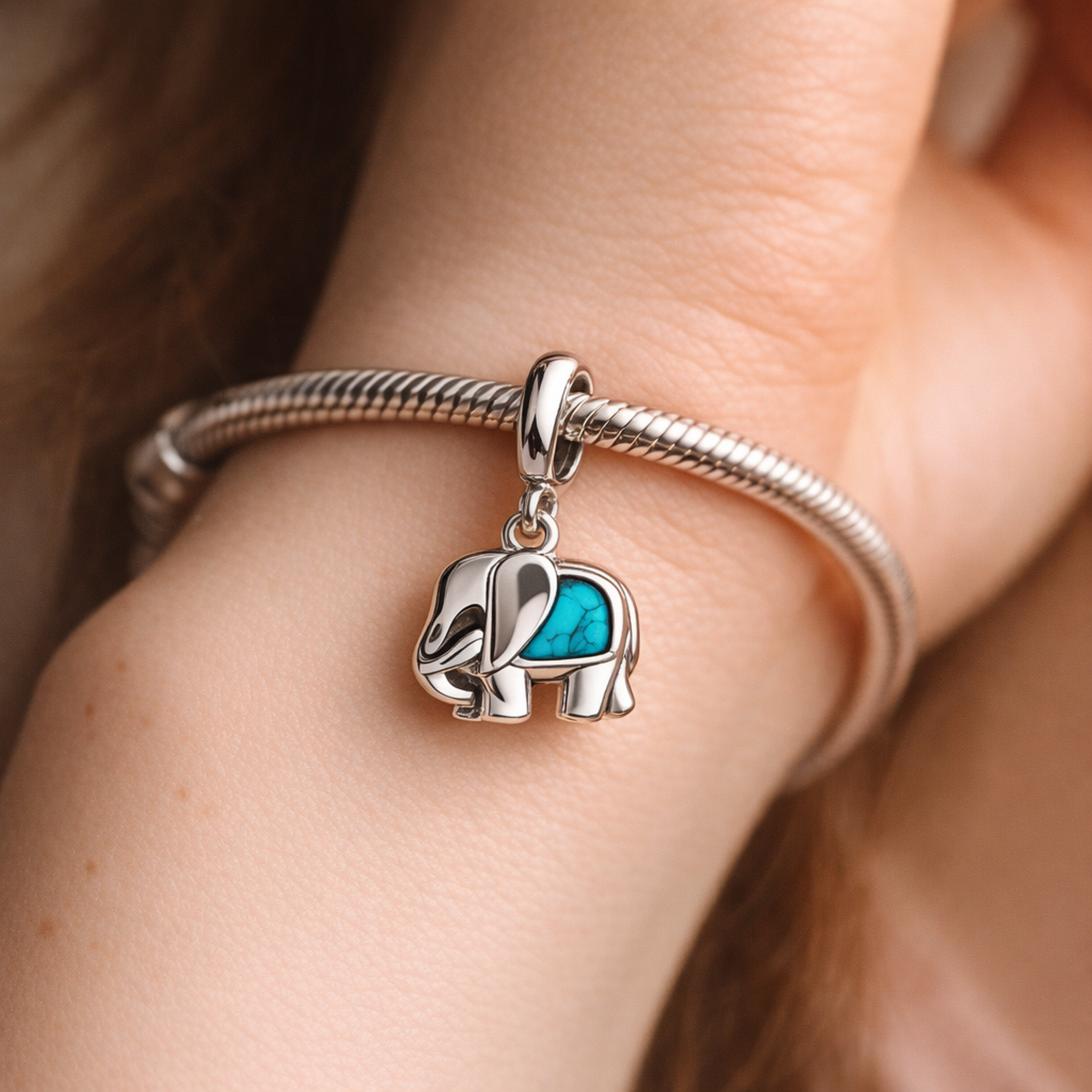 Turquoise-colored Elephant Mini Dangle Charm — worn on wrist